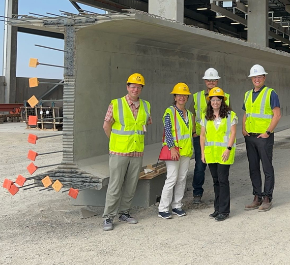 Four students show Order of the Engineer rings through the ceremony ring